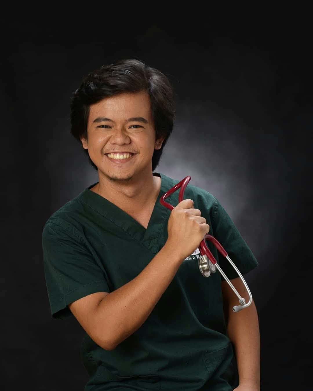 Dr. Raffy Villamayor gently examining a small dog